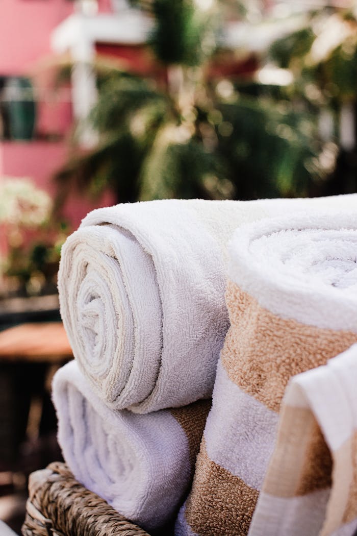High-quality cotton bath towels stacked outdoors, perfect for a relaxing spa day.